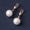 Classic beauty: natural round pearl earrings set on 14ct gold