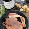 Young wild red grouse New York dressed in a pan with bacon, ready for roasting