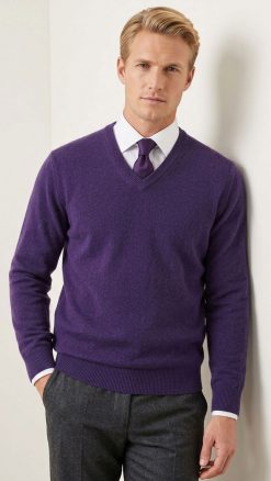 Model wearing the Massoti extra-fine Italian lambswool V-neck sweater in rich navy blue, layered over a white shirt and silk tie — elegant Italian knitwear for the modern gentleman.