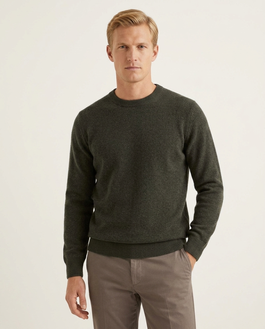 Man wearing Massoti Italian extrafine lambswool crew neck jumper in forest green, studio portrait – premium Italian knitwear for gentlemen