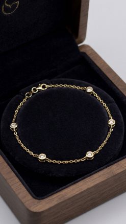 14ct gold diamond station bracelet with bezel-set diamonds presented in luxury gift box