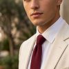 Men's pure silk red wine knitted tie worn with cream linen jacket and white shirt – modern sophisticated styling