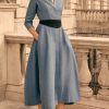 Model wearing the Blue Linen Shirt Dress, the Diane by Really Wildin blue with belted waist and flowing midi skirt.