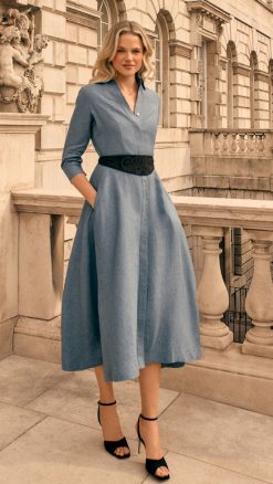 Model wearing the Blue Linen Shirt Dress, the Diane by Really Wildin blue with belted waist and flowing midi skirt.