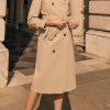 Model wearing the Really Wild Spring Trench Coat in stone with tailored silhouette and leather collar detailing.