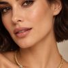 Italian-made gold-plated sterling silver necklace with three Swarovski crystal-set barrels, shown worn at the neckline